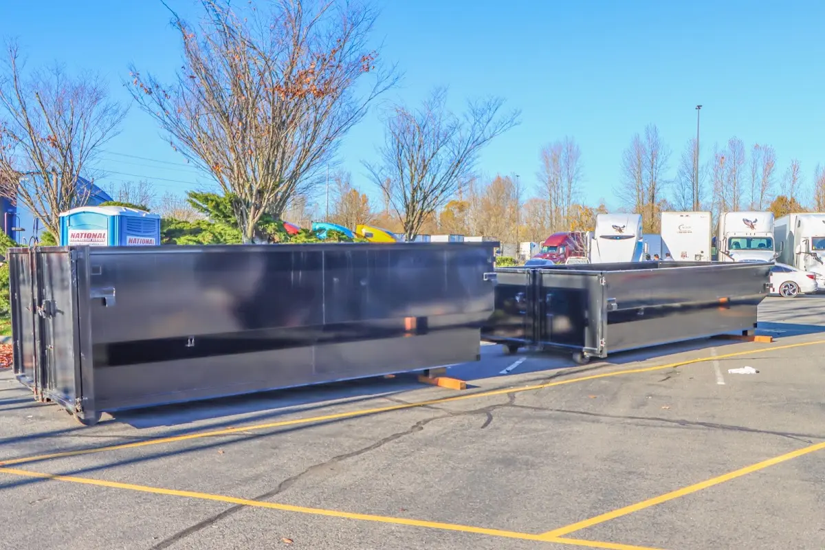 Professional dumpster rental service with roll-off container on residential driveway in Joplin